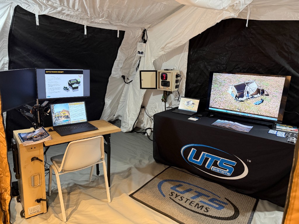 UTS Systems booth at AUSA Huntsville with Battle Wagon presentation, dual displays, and mobile command center demo